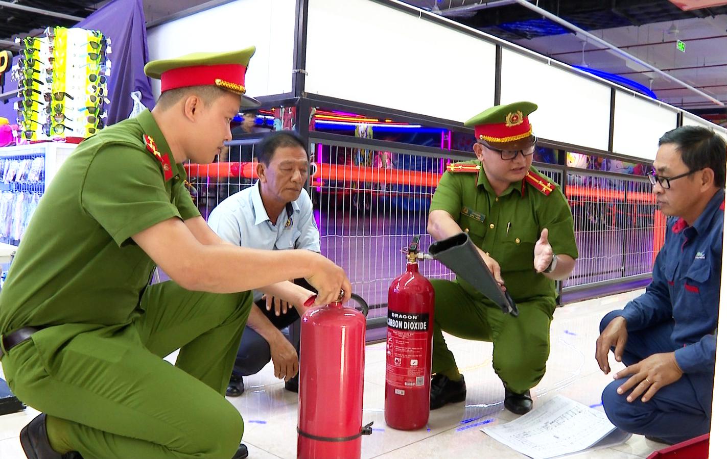 Cảnh s&aacute;t PCCC v&agrave; CNCH C&ocirc;ng an tỉnh An Giang kiểm tra, hướng dẫn Đội PCCC cở sở Trung t&acirc;m thương mại Zone C sử dụng b&igrave;nh chữa ch&aacute;y đ&uacute;ng kĩ thuật. Ảnh: Thiện Thanh