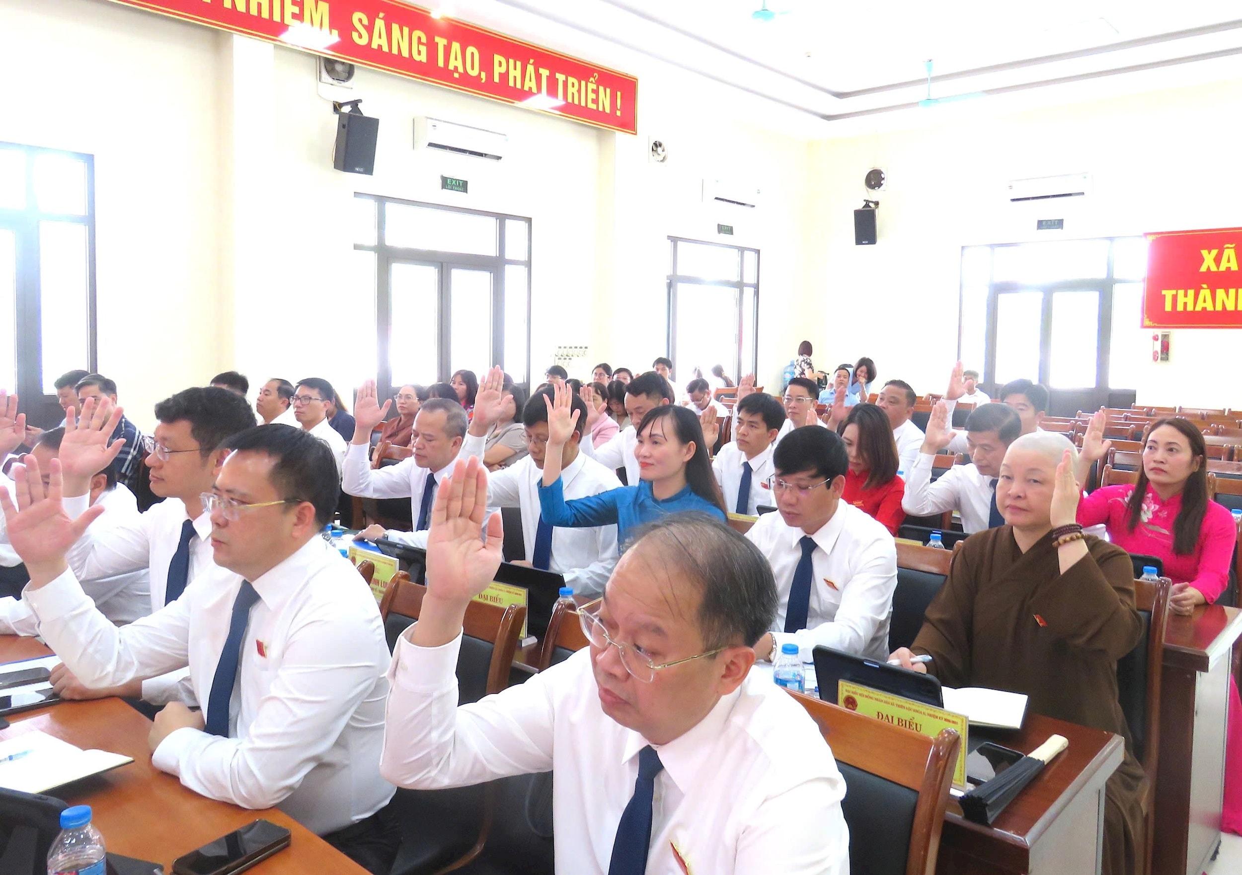 Các đại biểu HĐND xã biểu quyết thông qua các nghị quyết tại kỳ họp. Ảnh: Tú Linh.