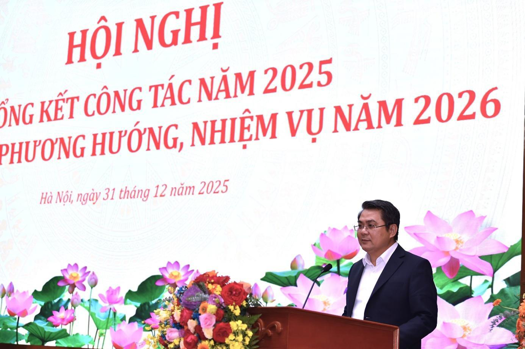 A person standing at a podium with a microphone and flowers  AI-generated content may be incorrect.