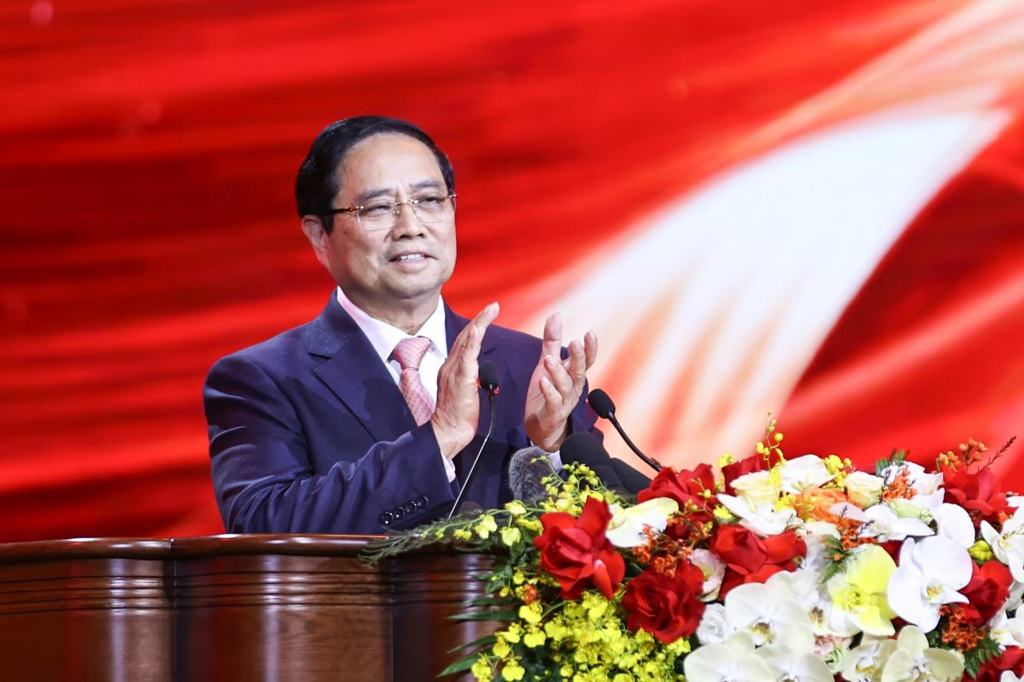 A person in a suit and tie standing at a podium with flowers

AI-generated content may be incorrect.