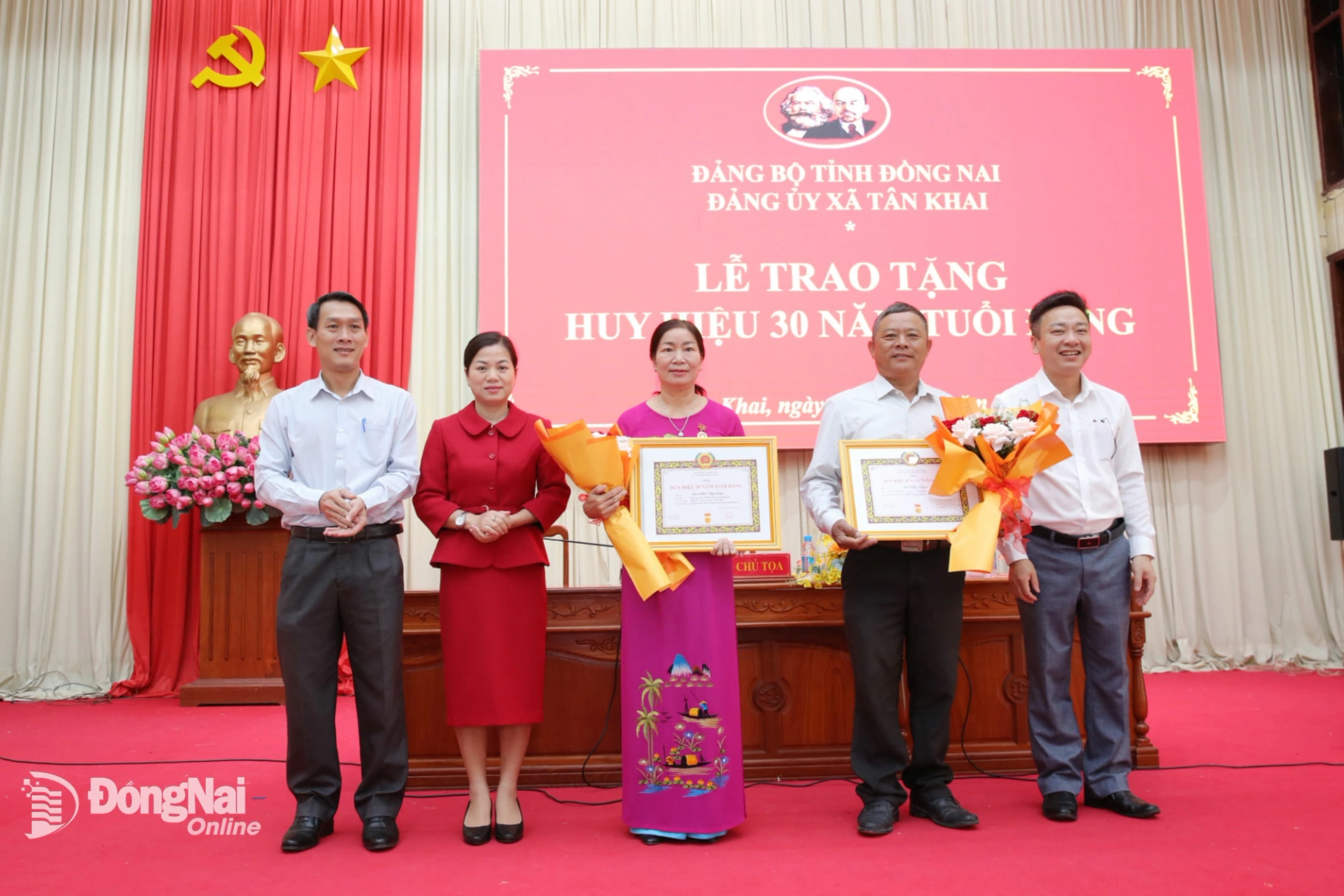 Tỉnh ủy viên, Phó Trưởng ban Tổ chức Tỉnh ủy Đồng Nai Đỗ Đức Hòa và lãnh đạo xã Tân Khai tặng hoa, trao Huy hiệu 30 năm tuổi Đảng cho các đảng viên. Ảnh: Trương Hiện  