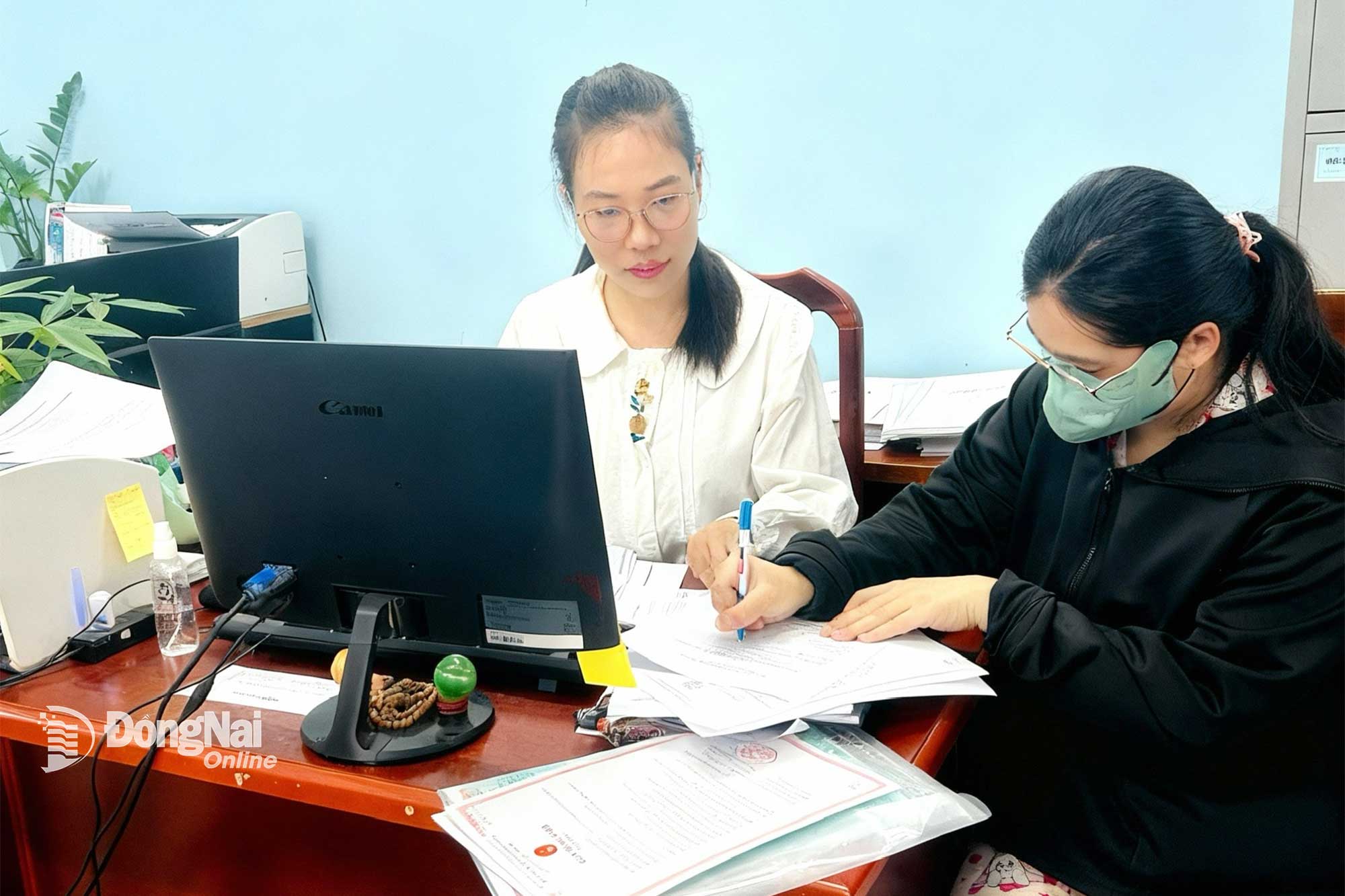 Phụ nữ sinh đủ 2 con trước 35 tuổi làm thủ tục đăng ký nhận tiền hỗ trợ tại UBND xã Hưng Thịnh. Ảnh: Kim Liễu