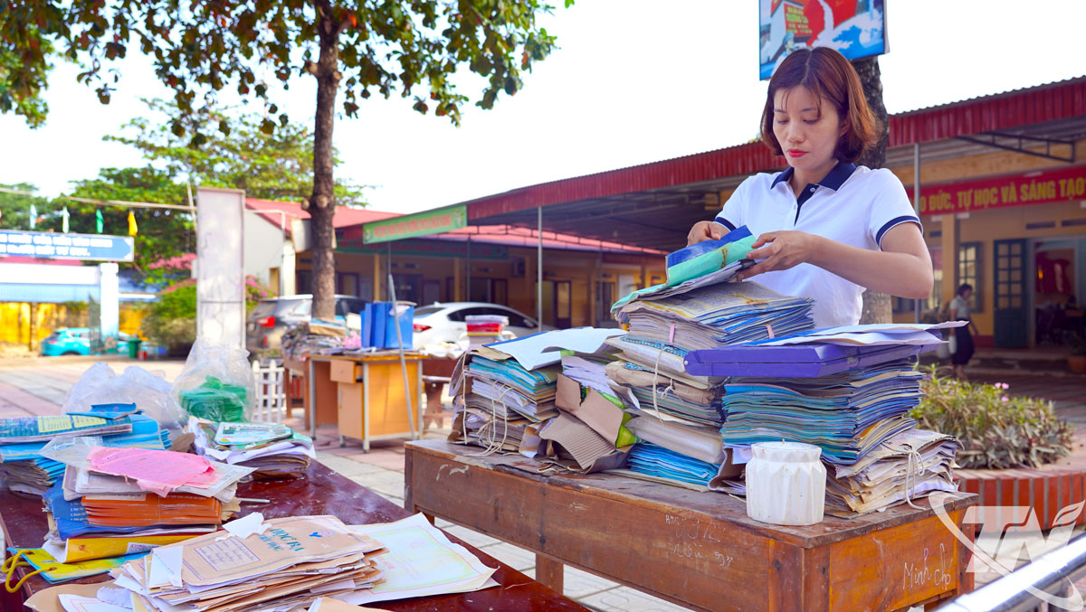 Tranh thủ ngày nắng, giáo viên Trường THCS Chùa Hang 1 hong phơi sách vở và tài liệu bị ướt do mưa lũ.