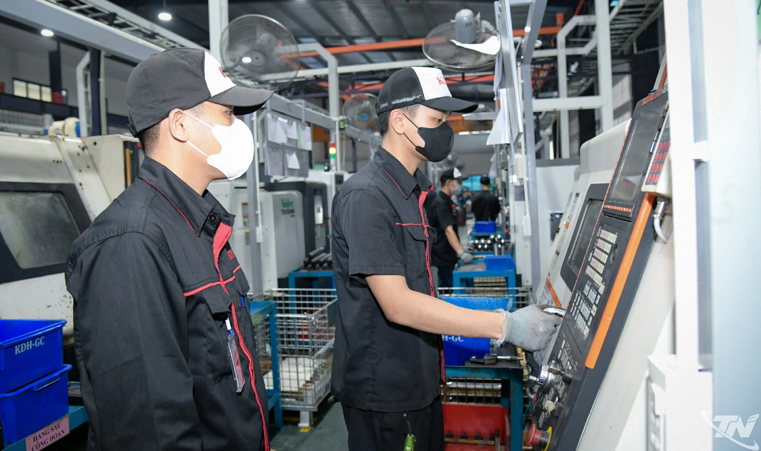 Từng là quân nhân, anh Hà Văn Cừ (người bên trái) hiện đảm nhiệm vai trò   Tổ trưởng dây chuyền, phát huy tốt kỹ năng tổ chức và kỷ luật trong môi trường   sản xuất.