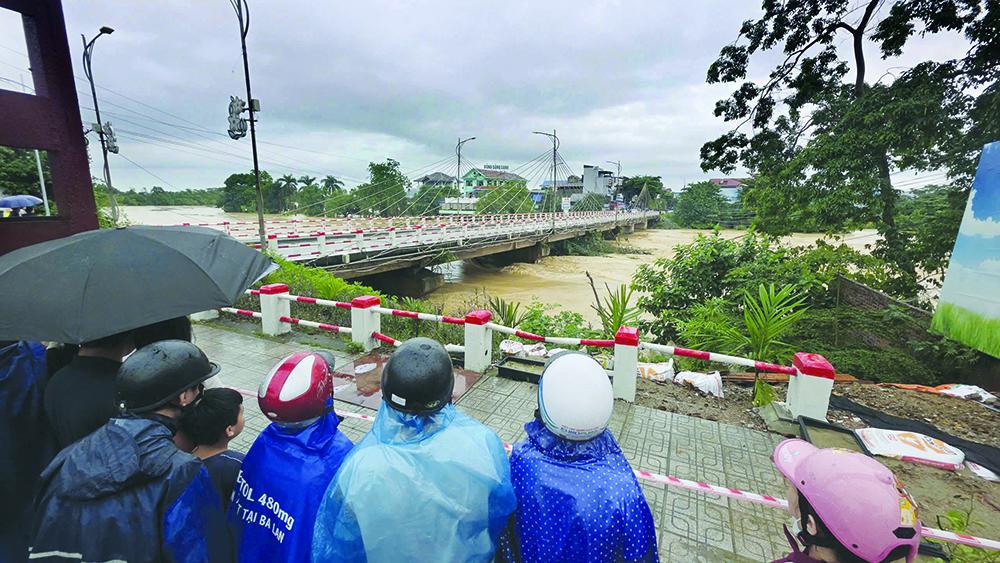 Nhiều người dân hiếu kỳ đứng xem hai bên cầu đã được lực lượng chức năng tuyên truyền, nhắc nhở rời khỏi khu vực nhằm đảm bảo an toàn cho chính mình và những người xung quanh