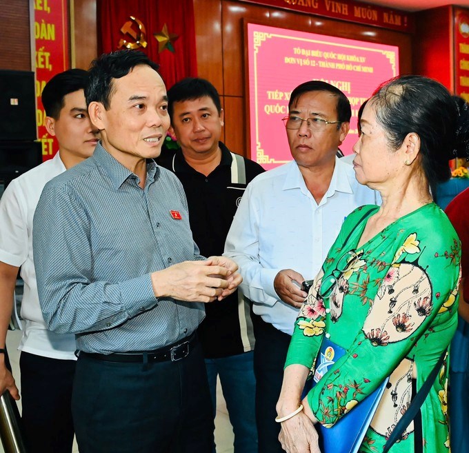 Bí thư Thành ủy TPHCM Trần Lưu Quang trò chuyện với cử tri sau buổi tiếp xúc. (Ảnh SGGP)