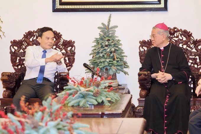 Bí thư Thành ủy TPHCM Trần Lưu Quang trao đổi với Đức Tổng Giám mục Giuse Nguyễn Năng, Tổng Giám mục Tổng Giáo phận TPHCM. (Ảnh: SGGP)